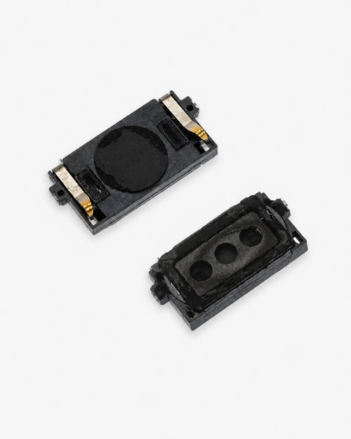 Two small black rectangular electronic components with gold metal contacts, shown on a plain light gray background.
