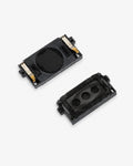 Two small black rectangular electronic components with gold metal contacts, shown on a plain light gray background.