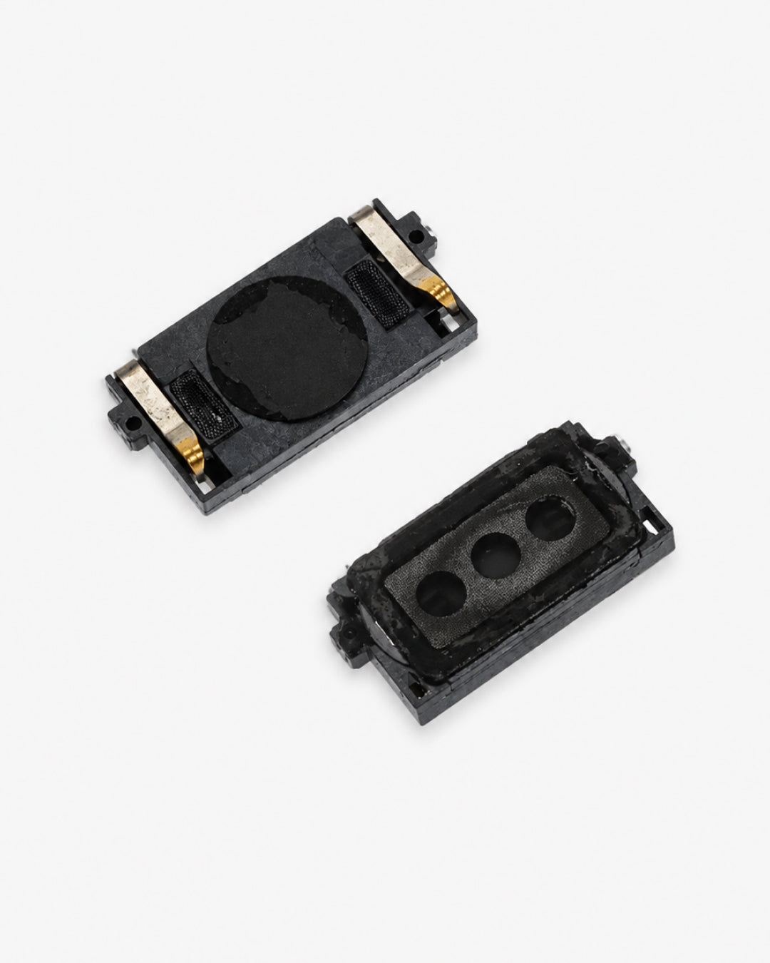 Two small black rectangular electronic components with gold metal contacts, shown on a plain light gray background.