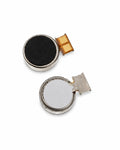 Two small round electronic button cell batteries with silver metal casings, one showing a black textured surface and the other showing a flat silver surface, both with attached gold flexible circuitry, on a white background.
