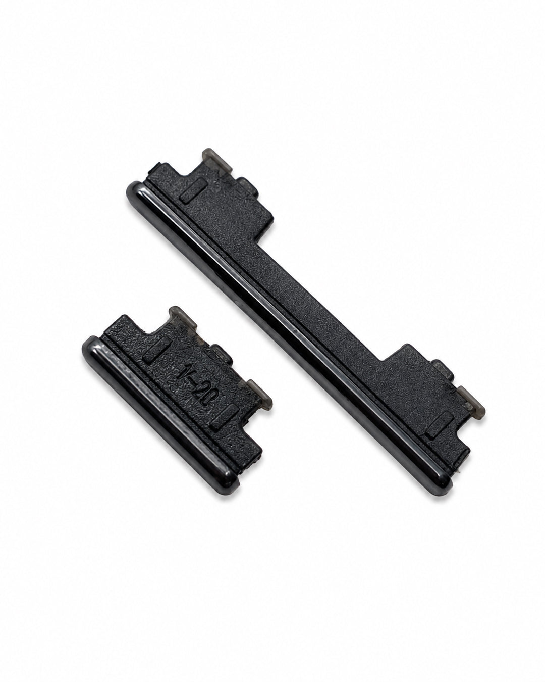 Two black plastic replacement key components shown on a plain white background.