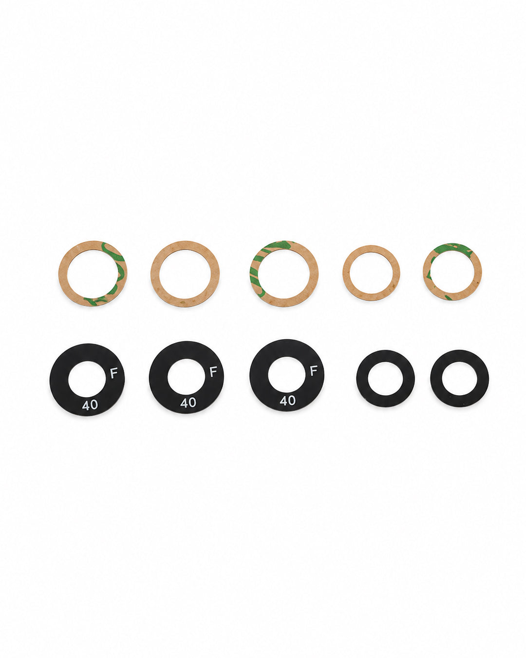 A set of bicycle headset washers, including tan paper washers with green adhesive backing and four black rubber washers labeled with size '40' and letter 'F', arranged on a plain white background.