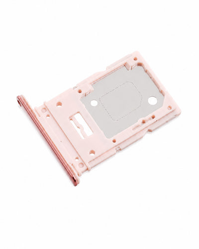 A replacement SIM card tray insert with a light pink plastic frame and a metallic silver inner plate, shown on a plain white background.