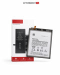 A replacement phone battery shown in front of its retail box on a clean white background. The battery is black with a white printed label and a small orange connector tab.