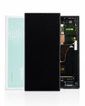 A replacement LCD screen and touch panel assembly for a Samsung mobile phone, shown with the black front panel in the center, the internal circuitry on the right, and the original white and mint green Samsung box on the left.