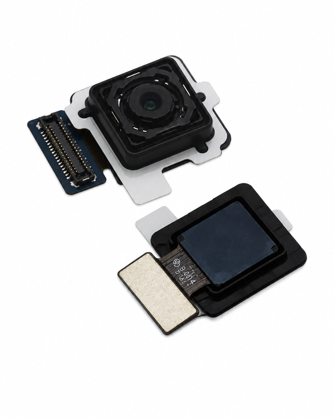 Two small electronic camera module components with black lenses, silver metal contacts, and adhesive pads, photographed on a clean white background.