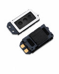 Two small rectangular electronic components, likely speaker or sensor modules, shown on a plain white background. One module is oriented with a white top plate and black mesh grille, while the other shows the black side with gold contact pads.