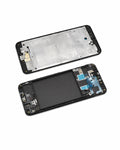 A disassembled smartphone front assembly shown on a white background, with the top half displaying the metallic inner frame and the bottom half showing the black screen area, internal components, and blue adhesive pads.