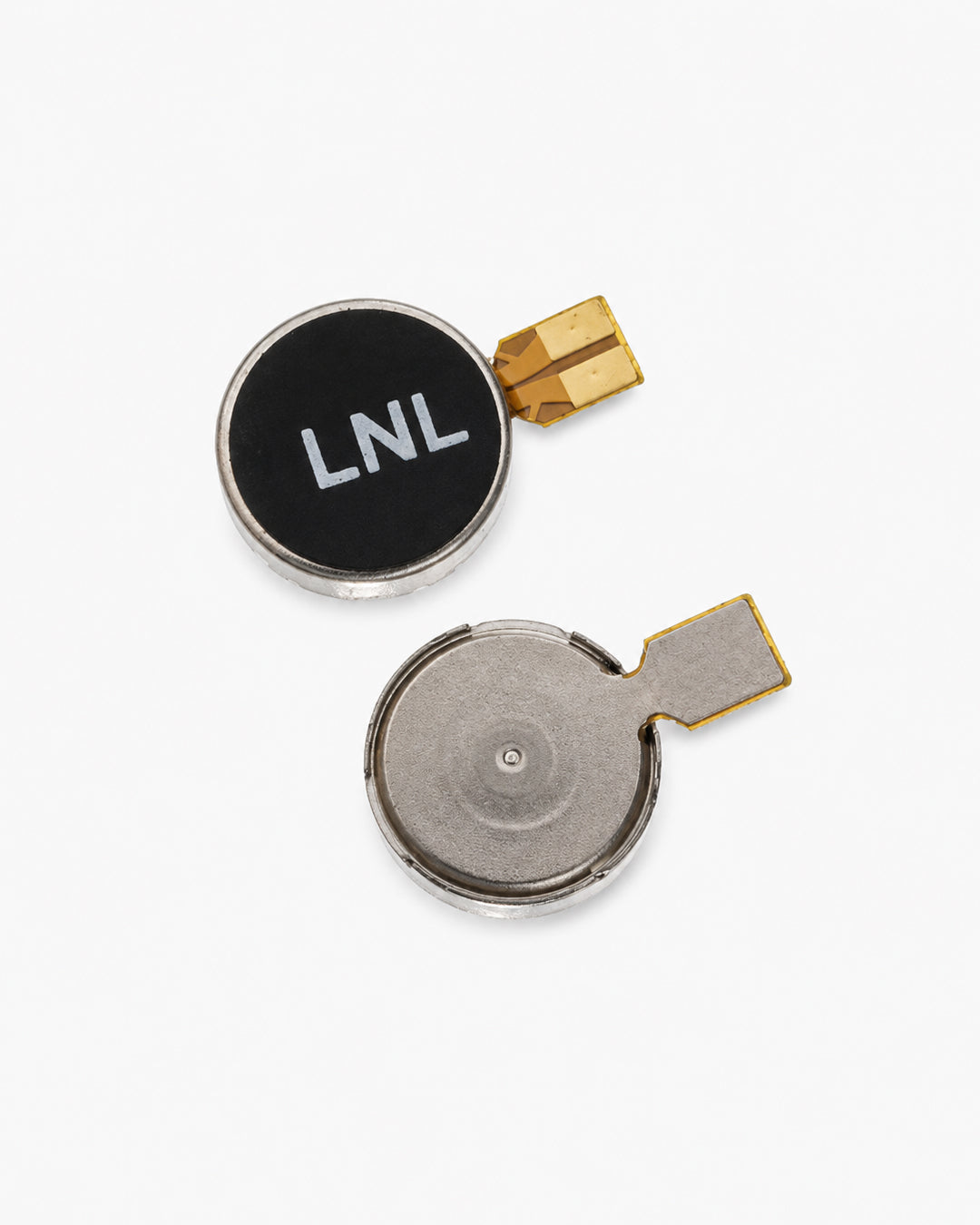 Two small round replacement battery components on a clean white background, one with a black face printed with 'LNL' in white and the other showing the metallic internal cell, both with gold-colored connector tabs.