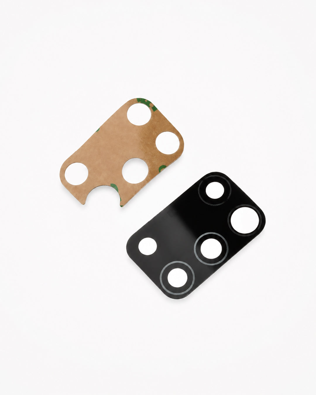 Two rectangular adhesive pads with circular cutouts, one in natural kraft brown with a small green patterned edge and one in glossy black, shown on a clean white background.