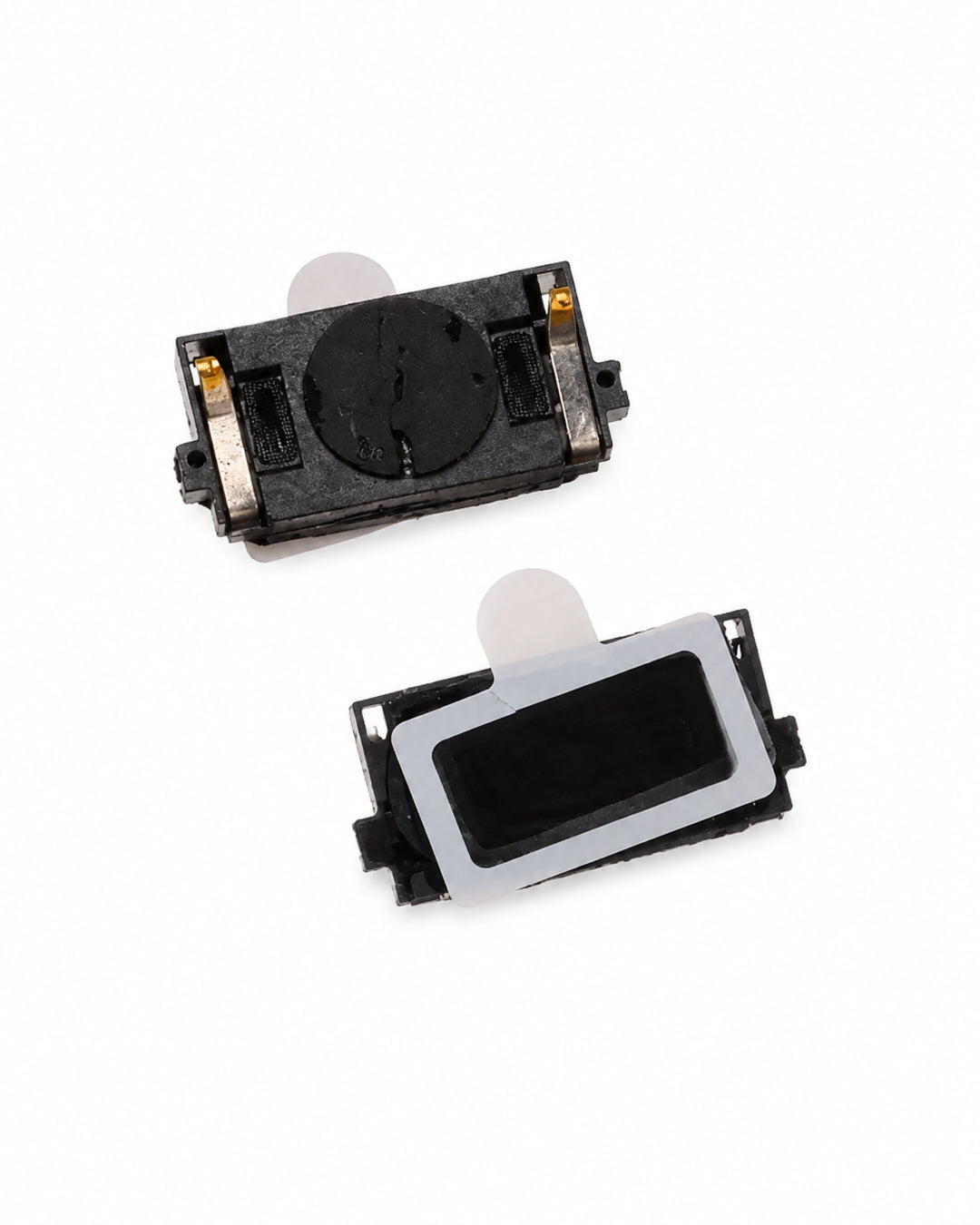 Two small black electronic button modules with gold contacts and white adhesive tabs, shown from different angles on a plain white background.