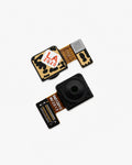 Two small electronic camera lens components with gold and black patterned flex circuits, one featuring a red and white 'LA 2020' sticker, photographed on a clean white background.